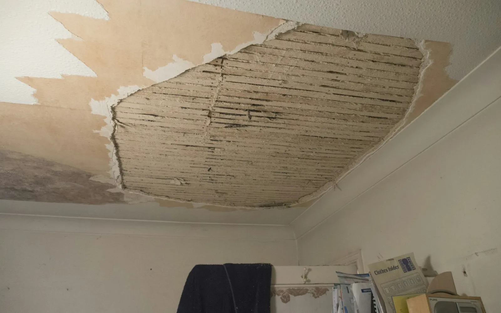 Water-damaged ceiling with sagging, broken drywall