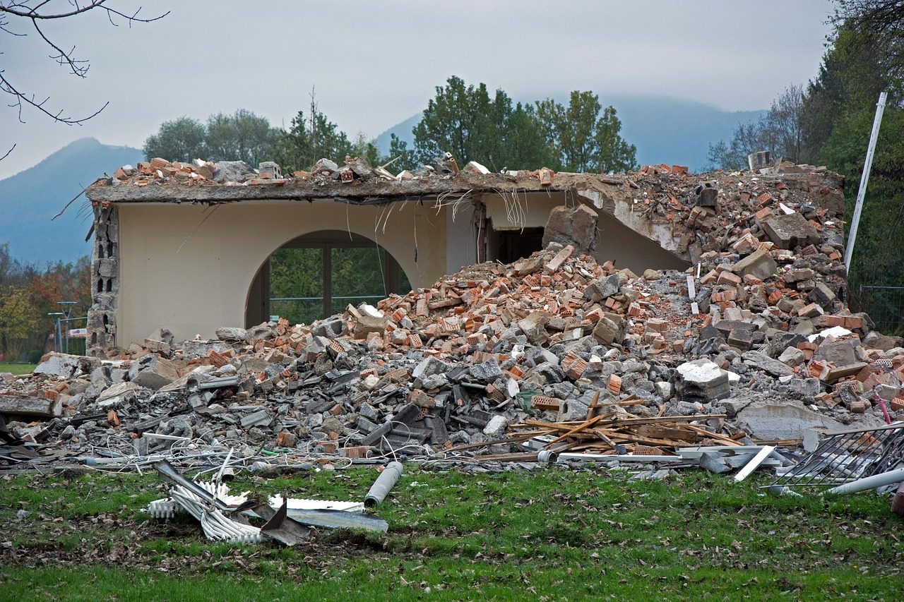 Collapsed building with fallen walls and structural debris