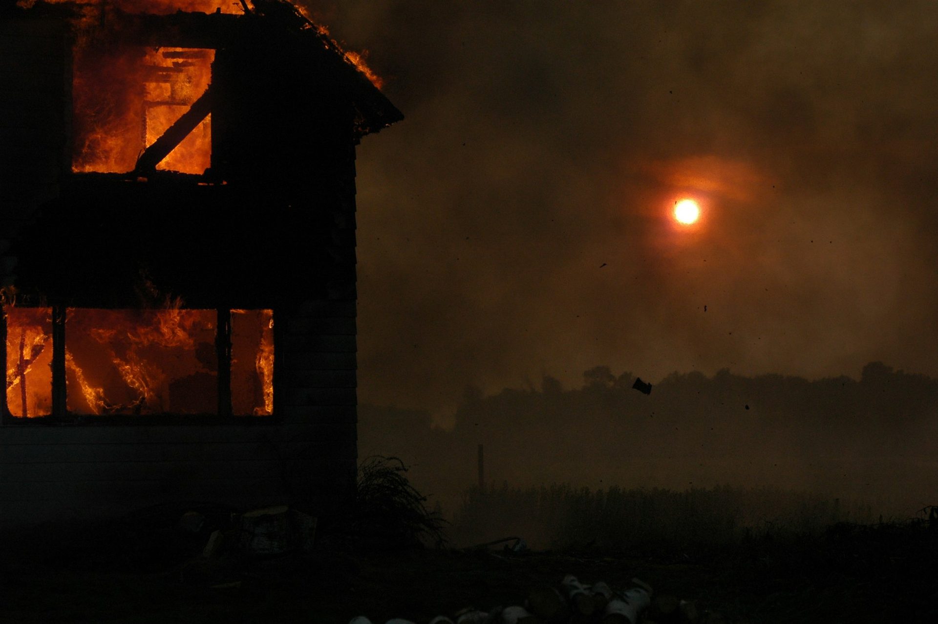 Residential house on fire with flames visible through windows