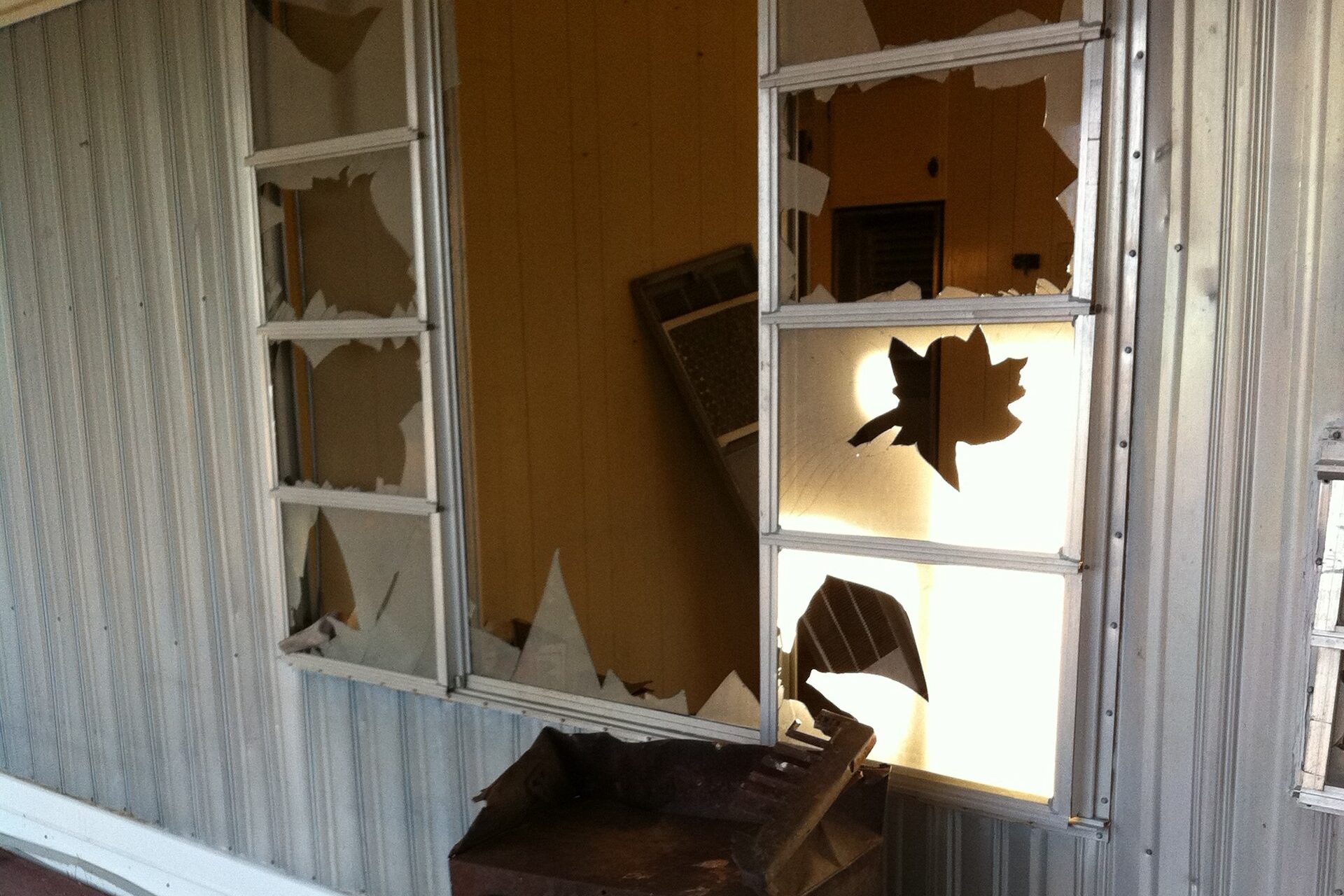 Residential window with smashed glass after a break-in