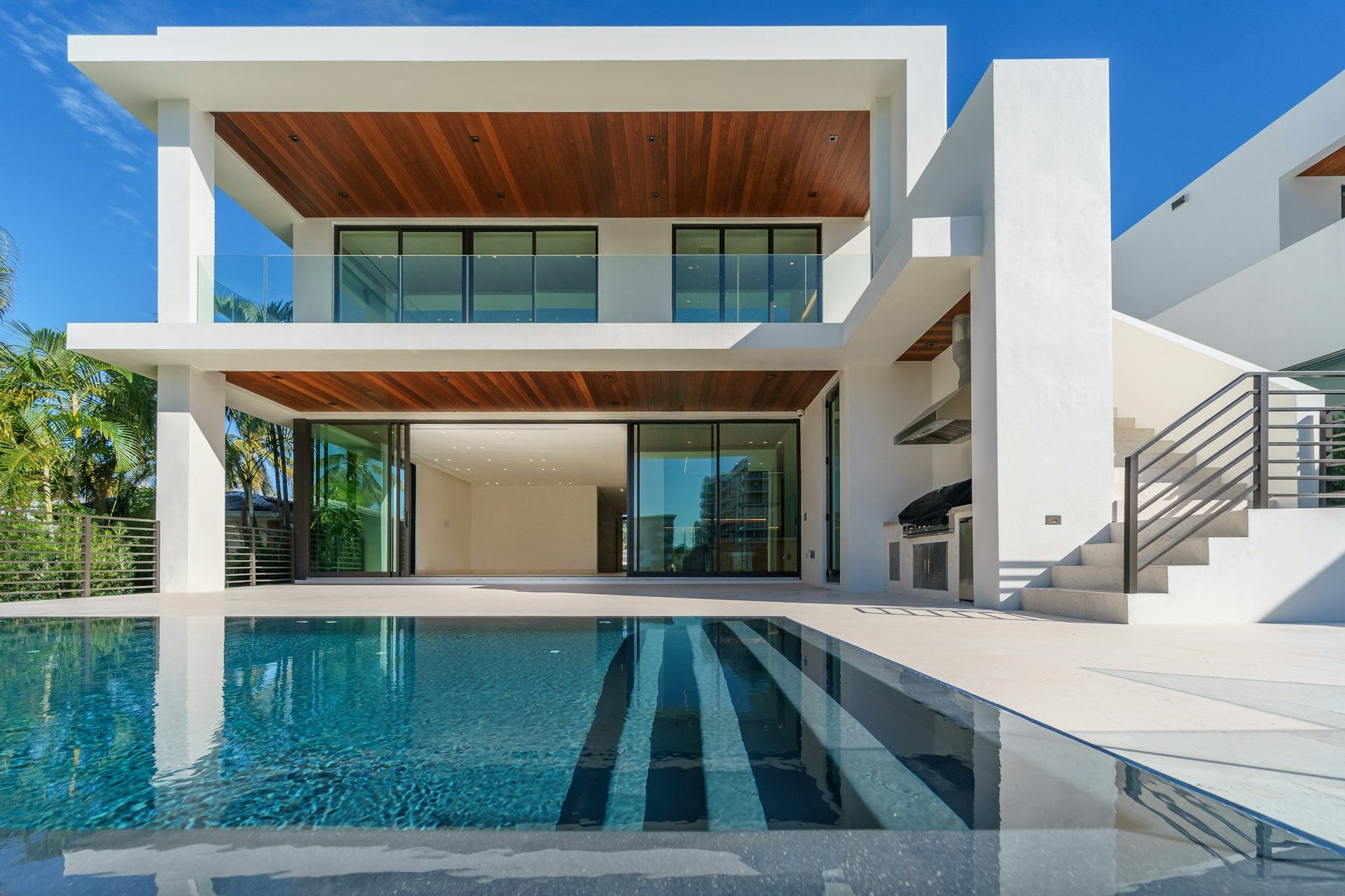 Contemporary luxury home with a pool and open glass walls
