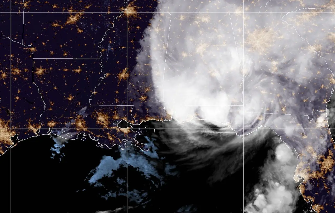 Night-time GOES-19 satellite image of Hurricane Isaias over the Florida Panhandle at landfall, with city lights visible across the Southeast