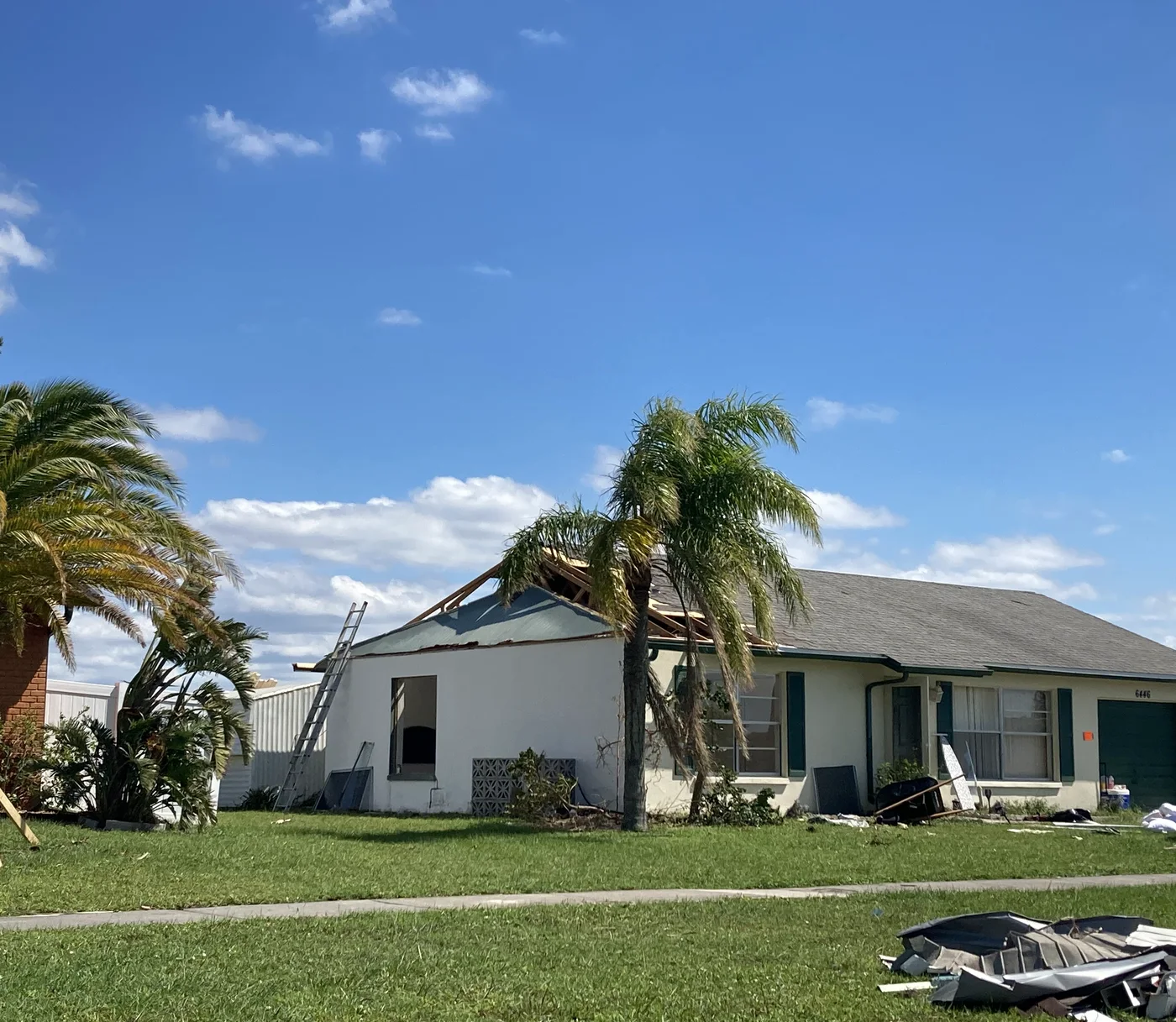 Illustrative Southwest Florida home with a large section of roof torn away after Hurricane Ian — not a client file