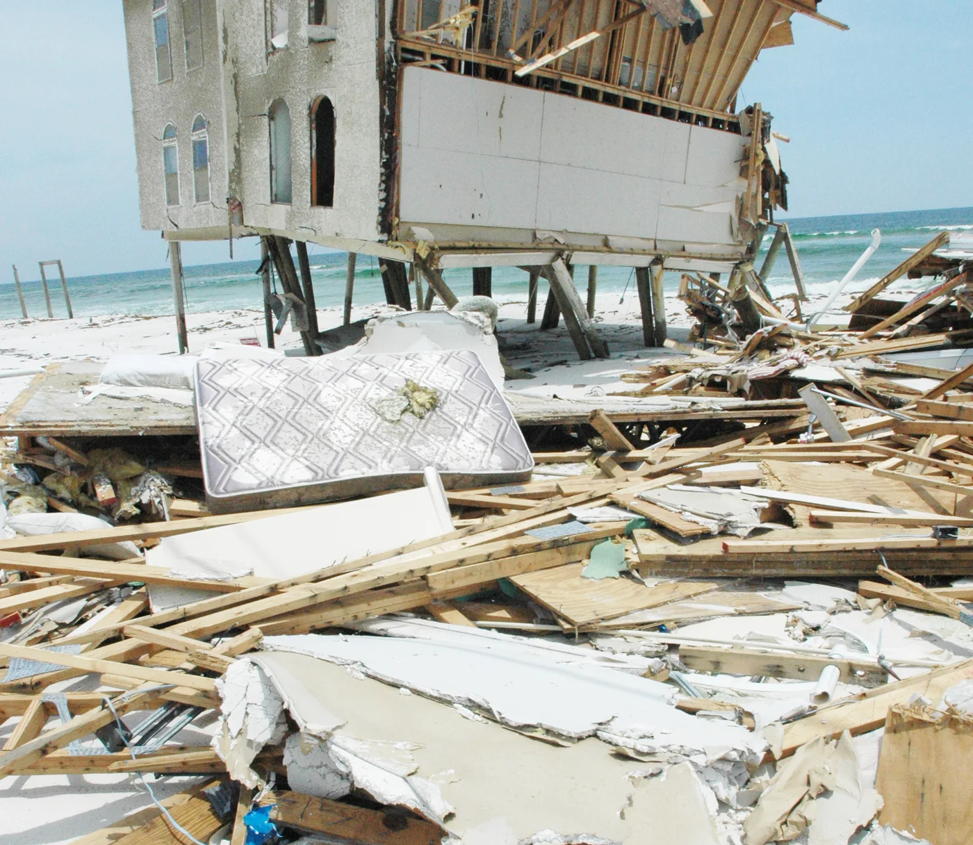 Illustrative beach-front home torn open by Hurricane Dennis — FEMA Photo Library; not a client file