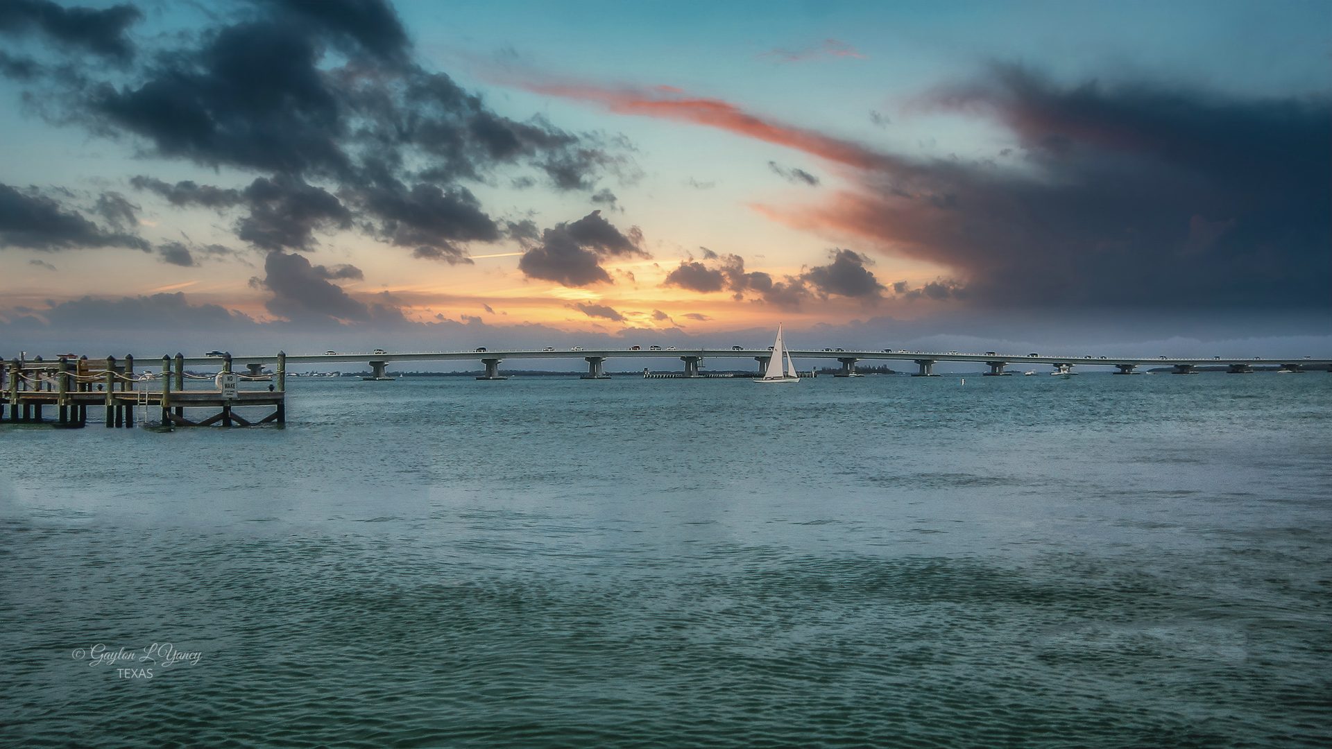 Fishing pier and Gulf water at sunset on the route from Fort Myers to Sanibel Island, Lee County
