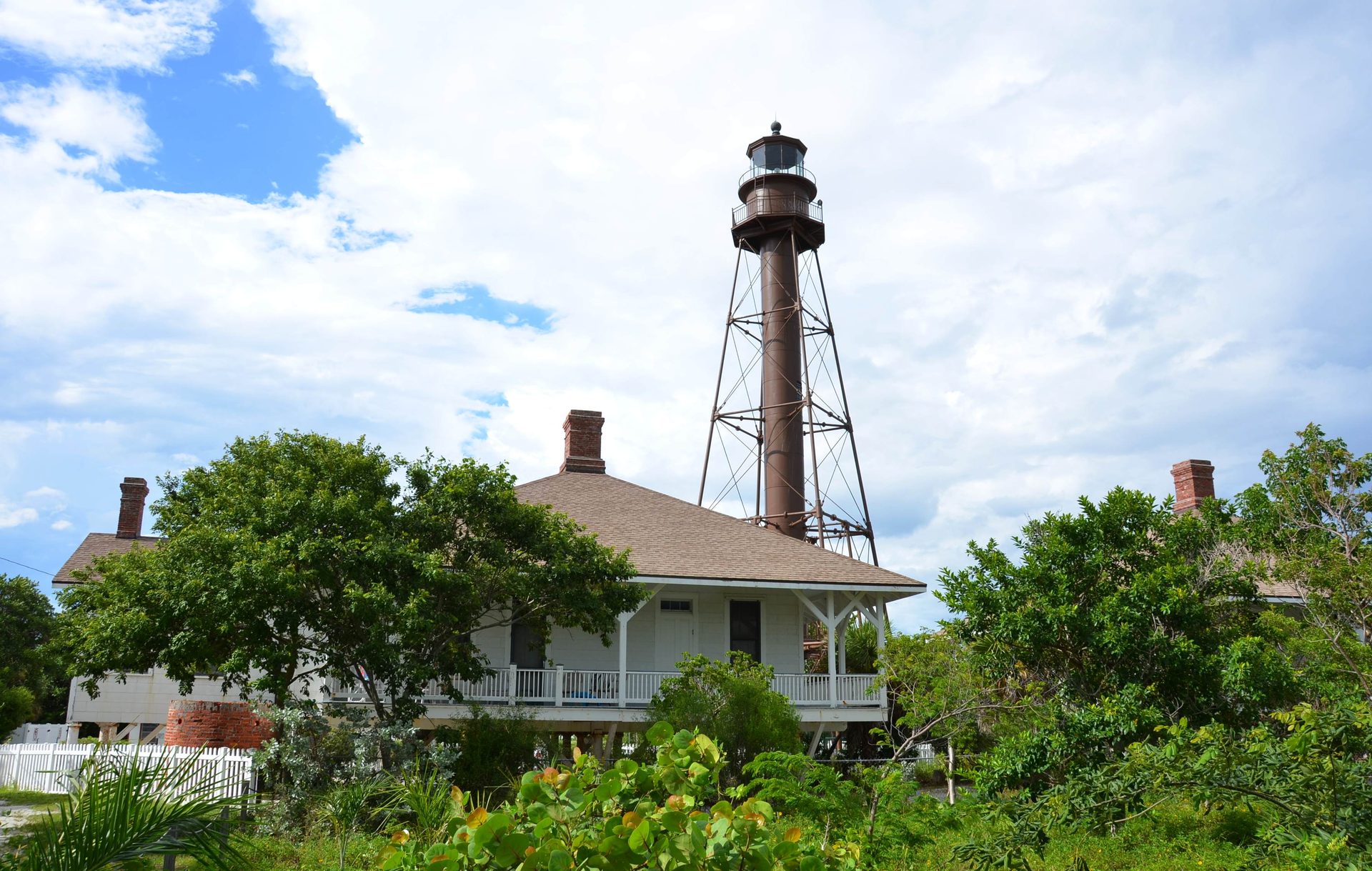 Sanibel Island Light and keeper’s cottages among trees on Sanibel Island