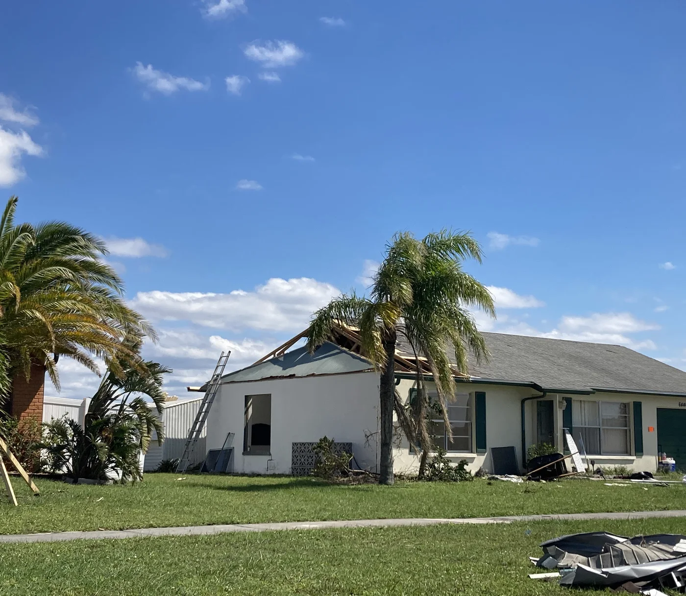 Illustrative Southwest Florida home with a large section of roof torn away after Hurricane Ian — not a client file