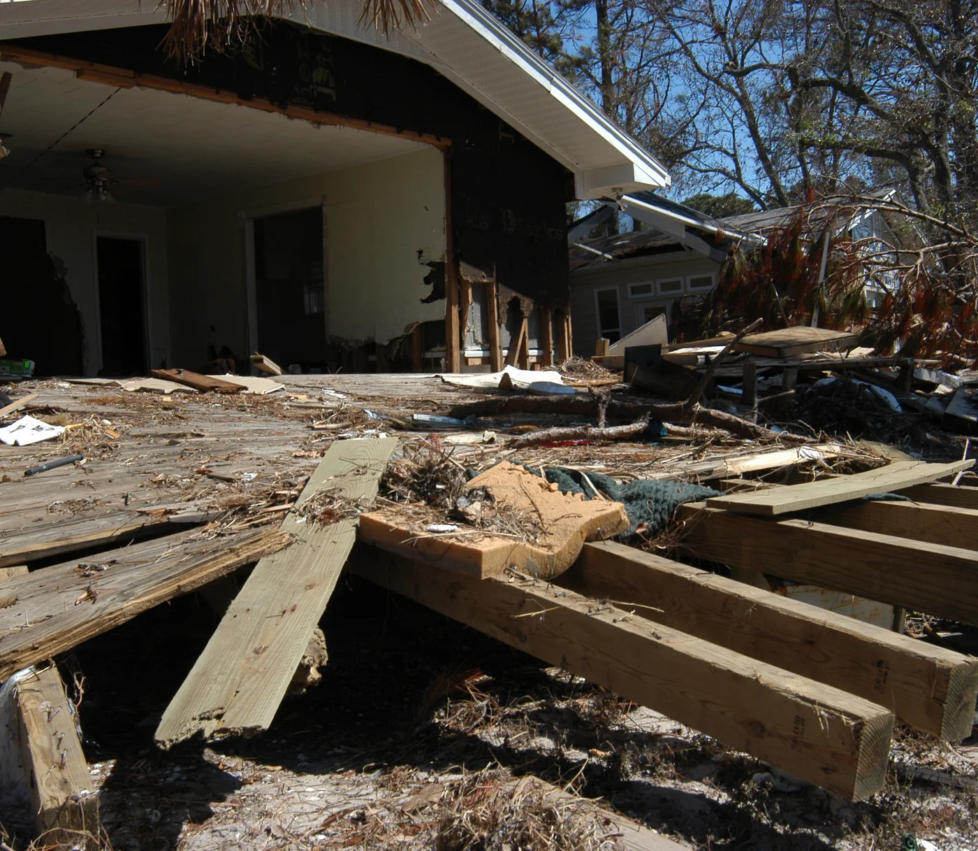 Illustrative Florida coastal home with porch and exterior wall torn away by storm surge — FEMA Photo Library; not a client file