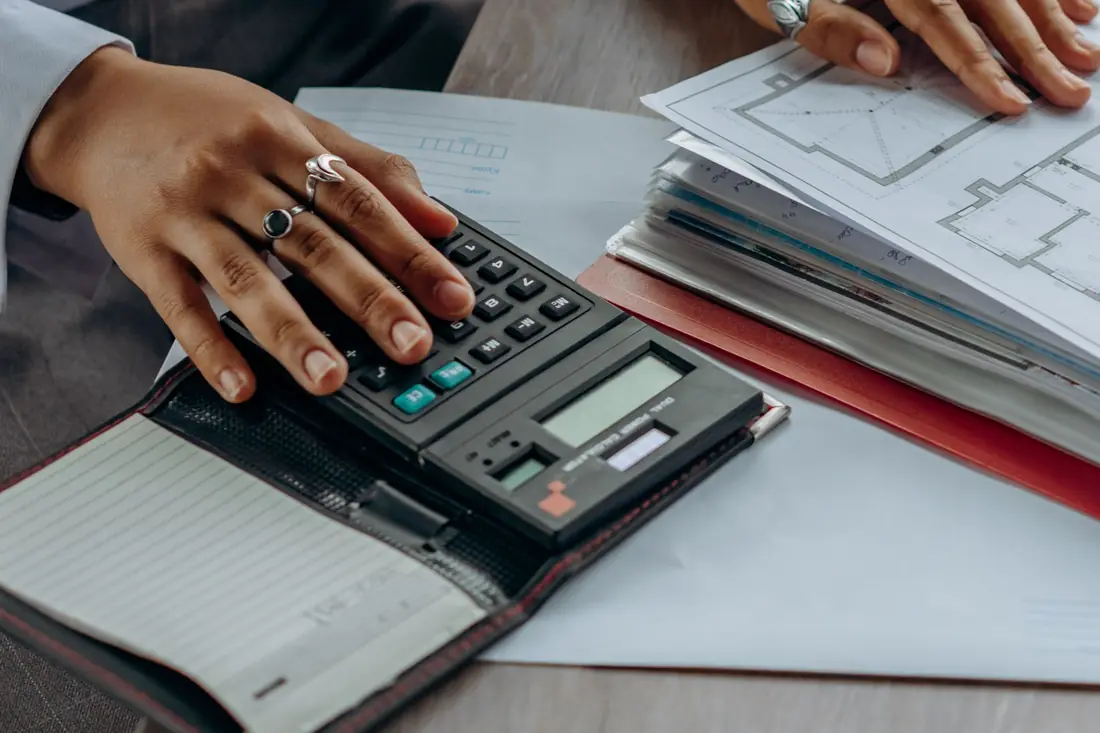 Calculator and repair estimate paperwork on a desk